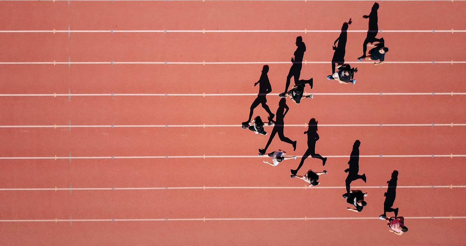 Runners on a track seen from above