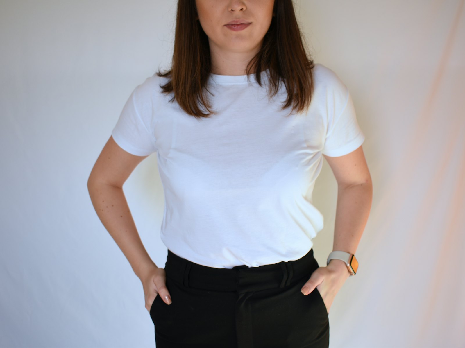 Person wearing a plain white crew neck t-shirt